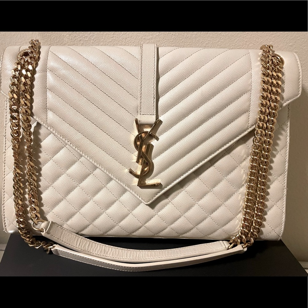 Gently used. No box or receipt. Does come with dust bag cover. LARGE Ivory/Gold.